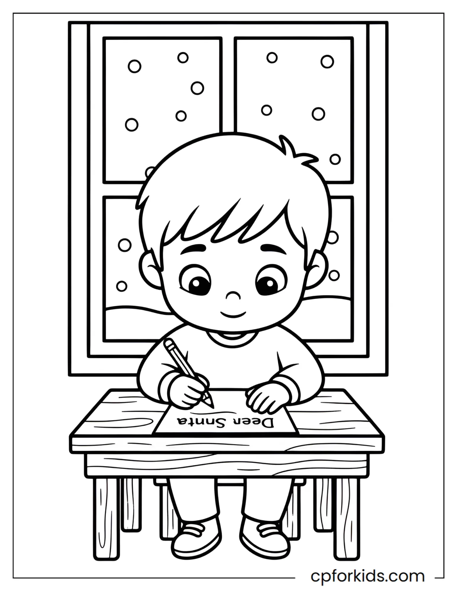 Boy writes a letter to Santa at his desk